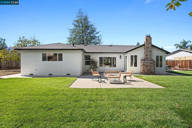 rear view of house with a yard and a patio