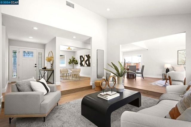 living room with light hardwood / wood-style floors and lofted ceiling