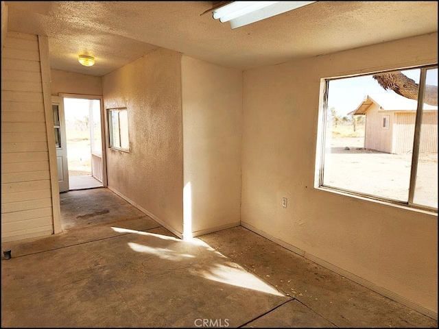 spare room with a textured ceiling