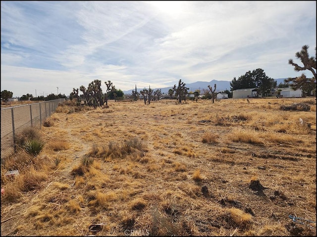 view of yard featuring a rural view and a mountain view