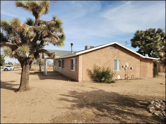 view of side of property with central AC unit