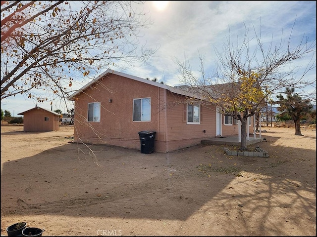 view of side of property with a storage shed