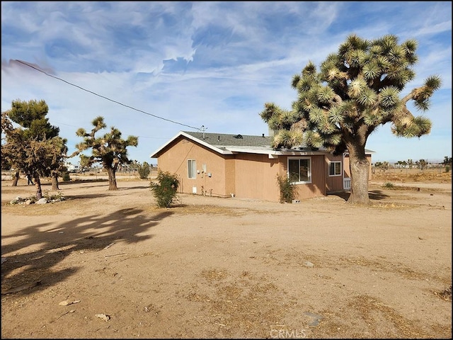 view of side of property with a rural view