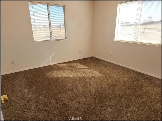 empty room featuring dark colored carpet