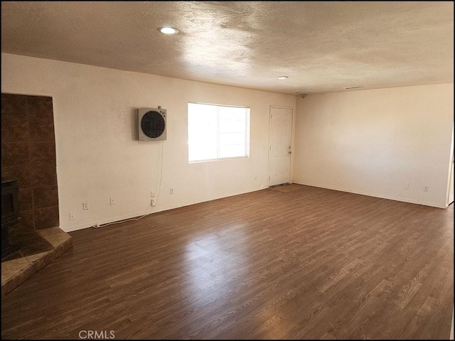 spare room with dark hardwood / wood-style flooring and a textured ceiling