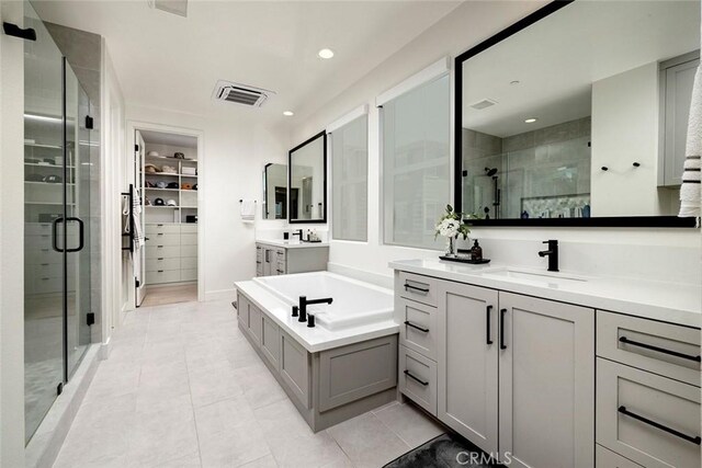 bathroom featuring tile patterned floors, vanity, and separate shower and tub