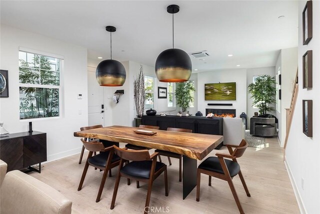 dining room with plenty of natural light and light hardwood / wood-style flooring