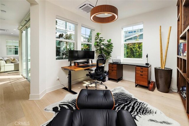 office space with light wood-type flooring