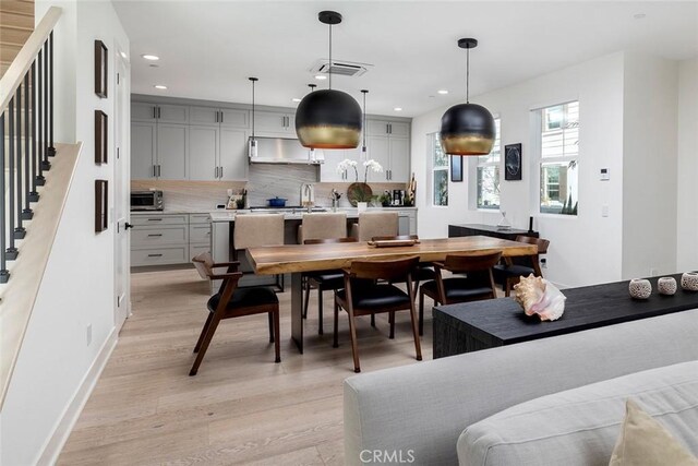 dining room with light hardwood / wood-style floors and sink