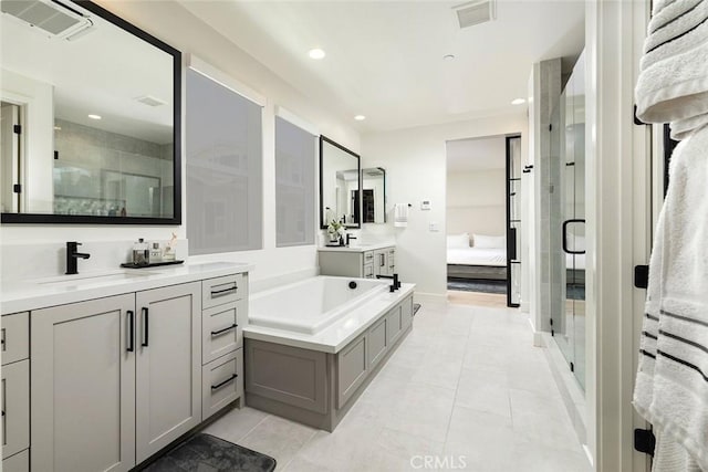 bathroom featuring a shower with door, tile patterned floors, and vanity