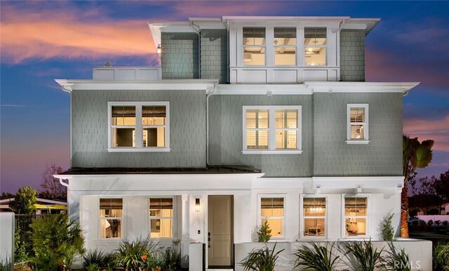 view of back house at dusk