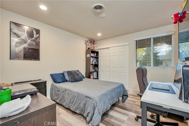 bedroom with a closet and light wood-type flooring