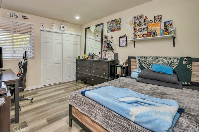 bedroom featuring a closet and light hardwood / wood-style flooring