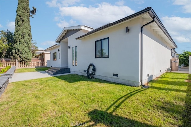 rear view of property featuring a yard