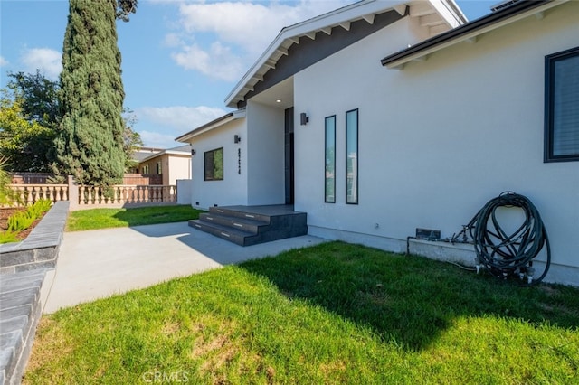 exterior space featuring a lawn and a patio area