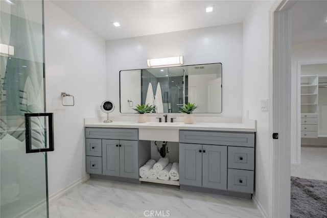 bathroom with vanity and a shower with door