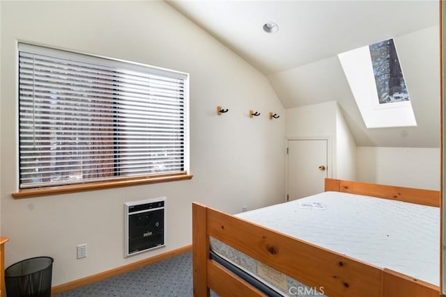 carpeted bedroom featuring vaulted ceiling with skylight and heating unit