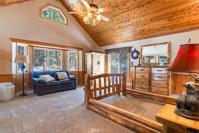 carpeted bedroom featuring high vaulted ceiling, wood ceiling, a wainscoted wall, and wood walls