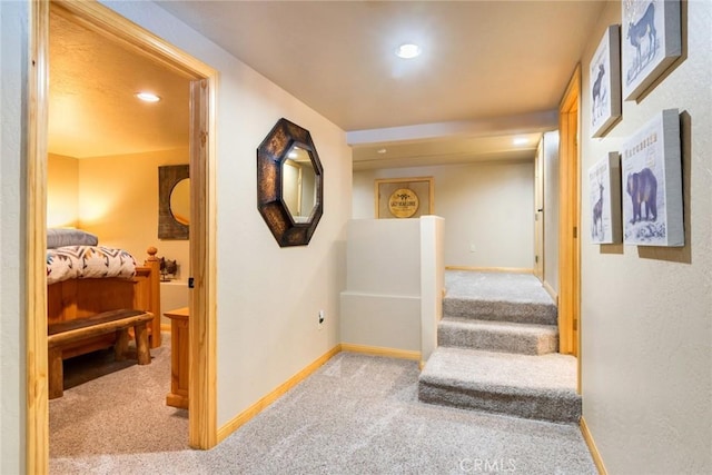 hall with light carpet, baseboards, and recessed lighting