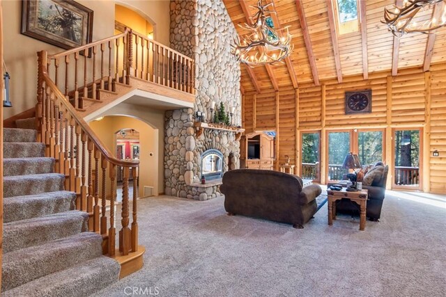 unfurnished living room featuring beamed ceiling, carpet, high vaulted ceiling, and wood ceiling