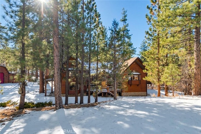 yard covered in snow featuring a wooden deck