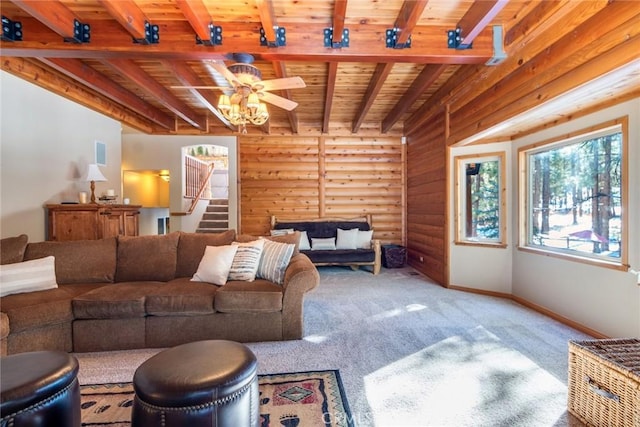 carpeted living room featuring beamed ceiling, ceiling fan, and wooden ceiling