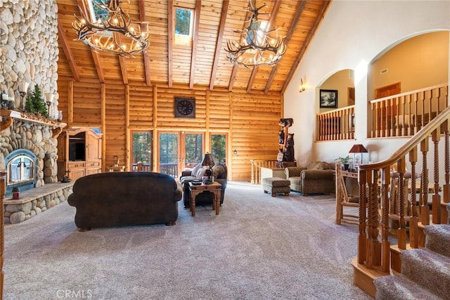 carpeted living room with wood ceiling, an inviting chandelier, high vaulted ceiling, a fireplace, and log walls