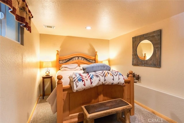 bedroom featuring carpet floors, visible vents, and baseboards