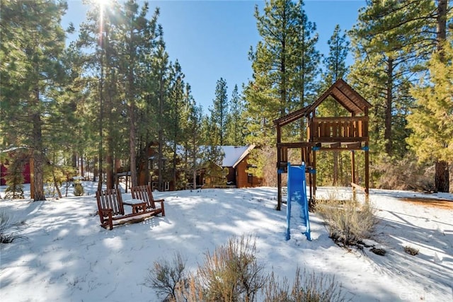 yard covered in snow with a playground