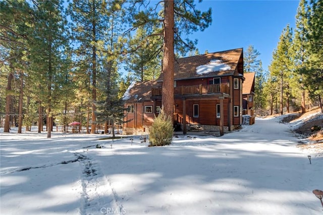 view of snow covered rear of property