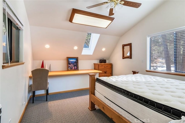 bedroom featuring lofted ceiling with skylight, ceiling fan, and baseboards