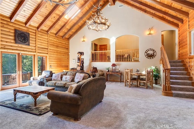 carpeted living room with beam ceiling, wood ceiling, an inviting chandelier, high vaulted ceiling, and log walls