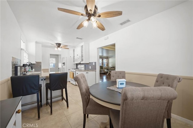 dining space featuring ceiling fan and light tile patterned floors