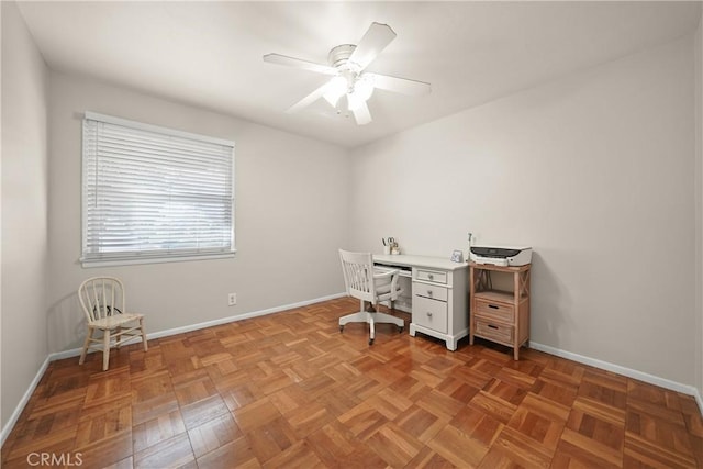 unfurnished office featuring light parquet floors and ceiling fan