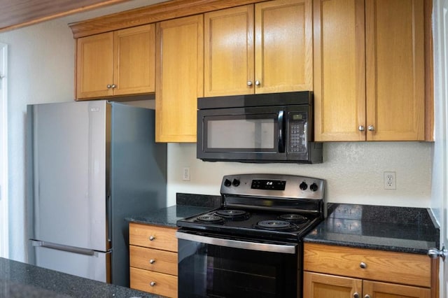 kitchen featuring backsplash, stainless steel appliances, and dark stone countertops