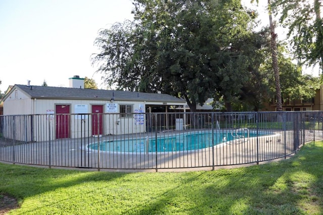 view of pool with a patio area and a yard