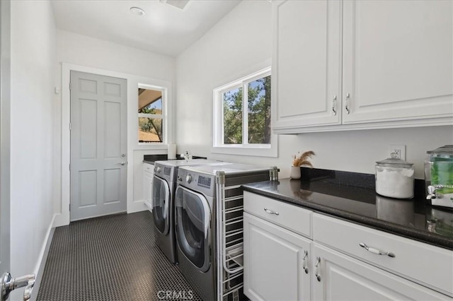 washroom featuring cabinets and independent washer and dryer