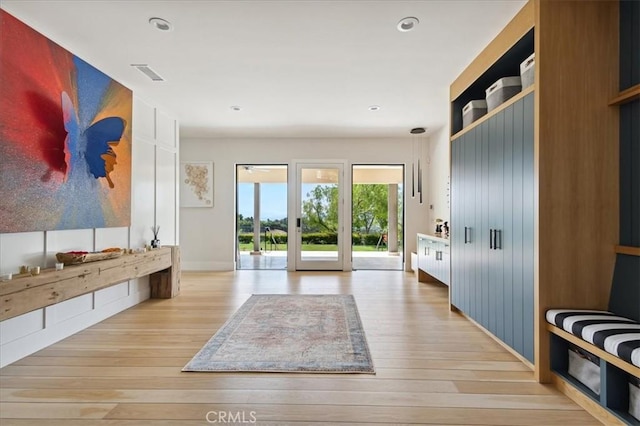 mudroom with light hardwood / wood-style flooring