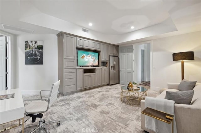 carpeted living room featuring a tray ceiling