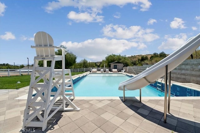 view of pool featuring a patio area and a water slide