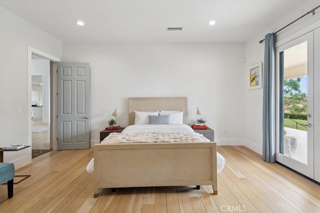 bedroom with access to outside and light wood-type flooring