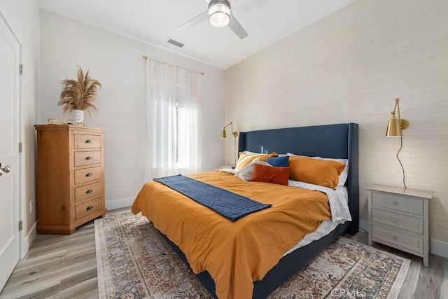 bedroom with ceiling fan and light hardwood / wood-style floors