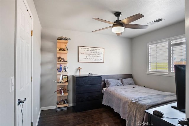 bedroom with ceiling fan and dark hardwood / wood-style floors