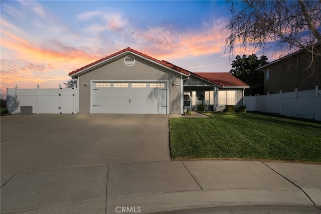 view of front of home featuring a garage and a lawn