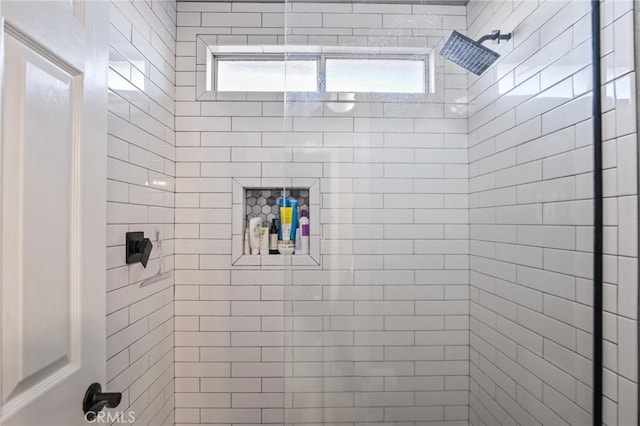 bathroom with a tile shower