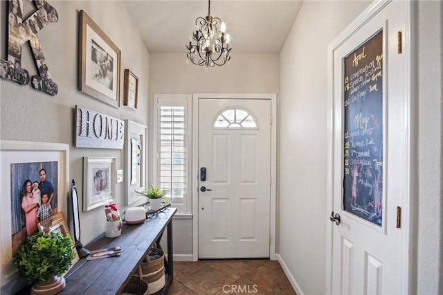 foyer entrance featuring plenty of natural light and a notable chandelier