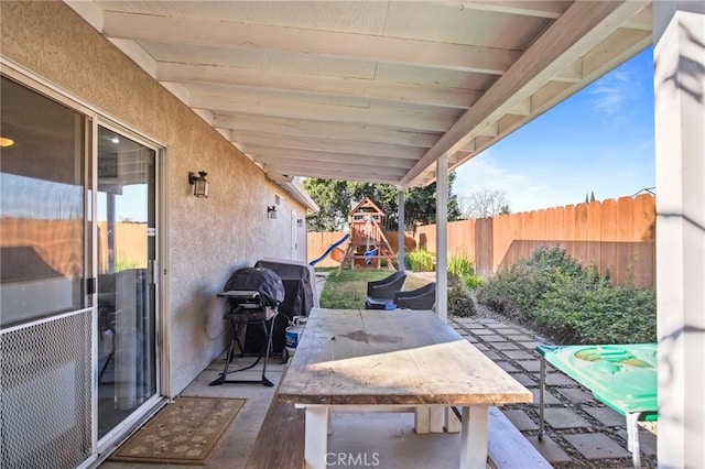 view of patio with a grill and a playground