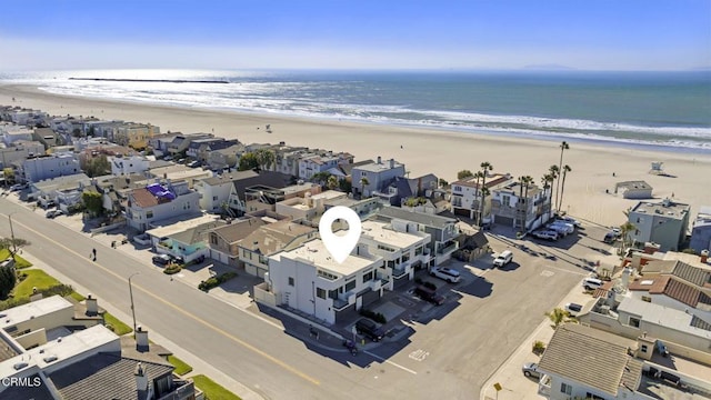 drone / aerial view featuring a water view and a view of the beach