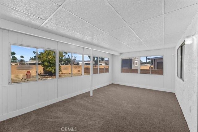 unfurnished sunroom with a drop ceiling