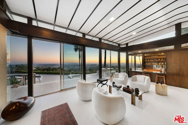 interior space featuring bar area and floor to ceiling windows